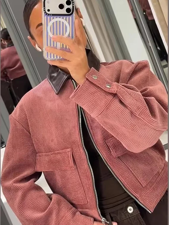 Women's cropped zip-up bomber jacket with flap pockets by Jesie-London, shown in a stylish, fitted design with front zipper detail.