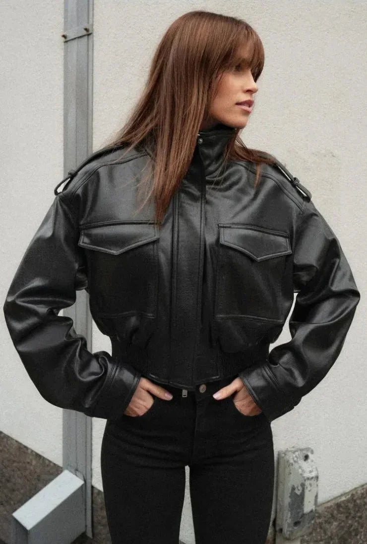 Women's zip-up biker style jacket with front pockets in a leather-look finish, by Jesie-London, cropped design for a modern fit.