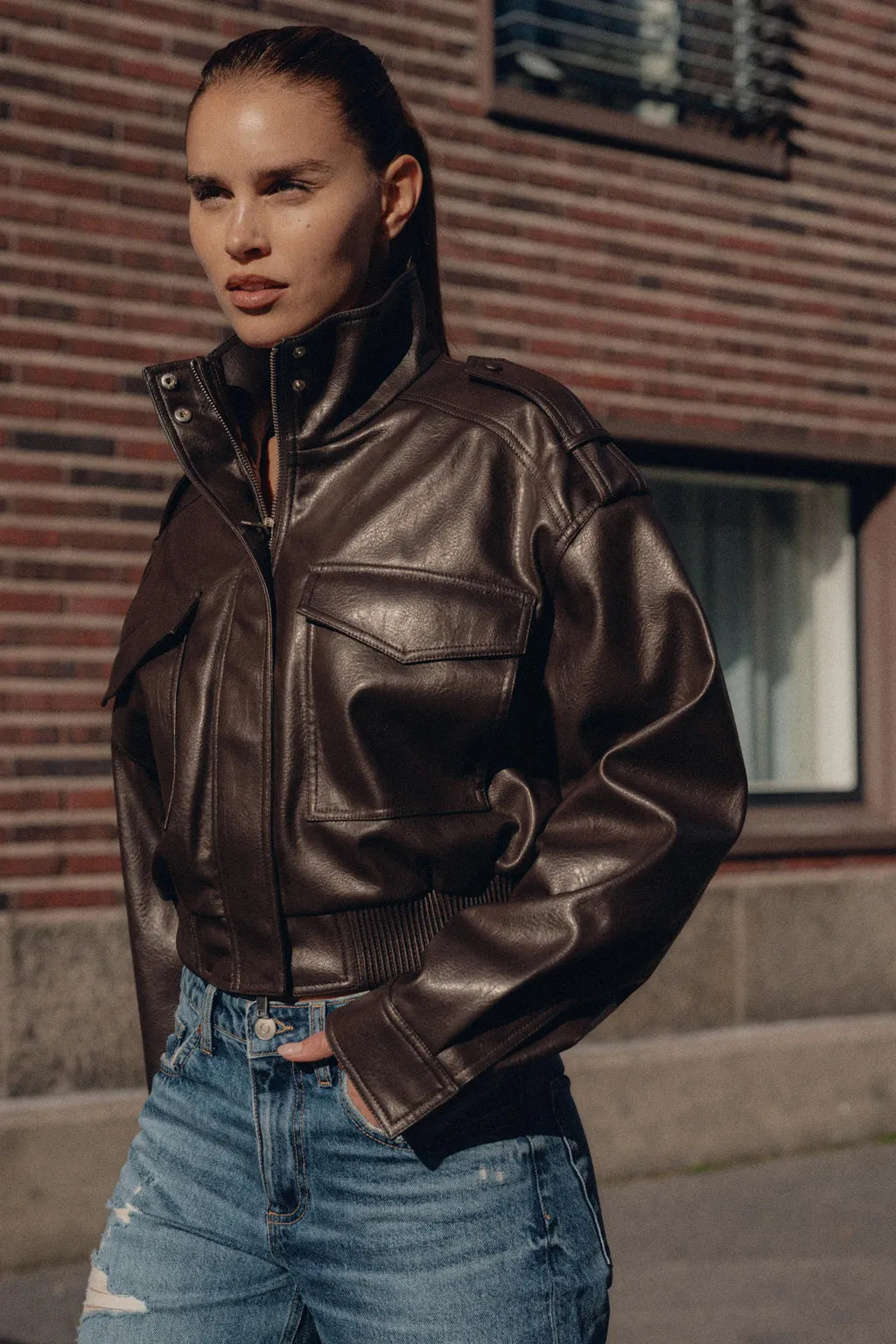 Women's zip-up biker style jacket with front pockets in a leather-look finish, designed by Jesie-London.