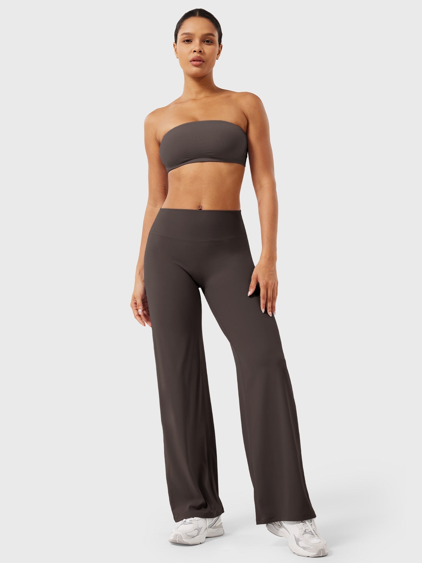 Dark brown women's high waist flared pants from Jesie-London's Millie summer collection, showcasing the relaxed fit and stylish silhouette.