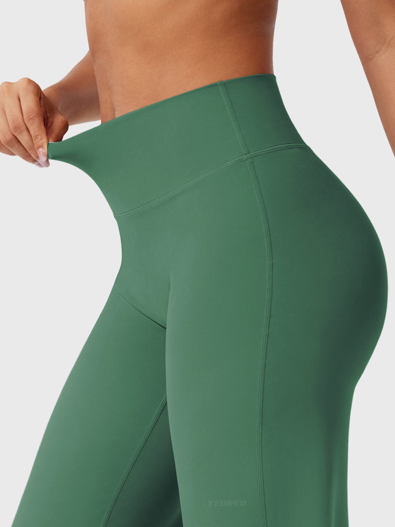 Dark green women's high waist flared pants by Jesie-London, featuring a summer-friendly, stylish fit and wide-leg design.