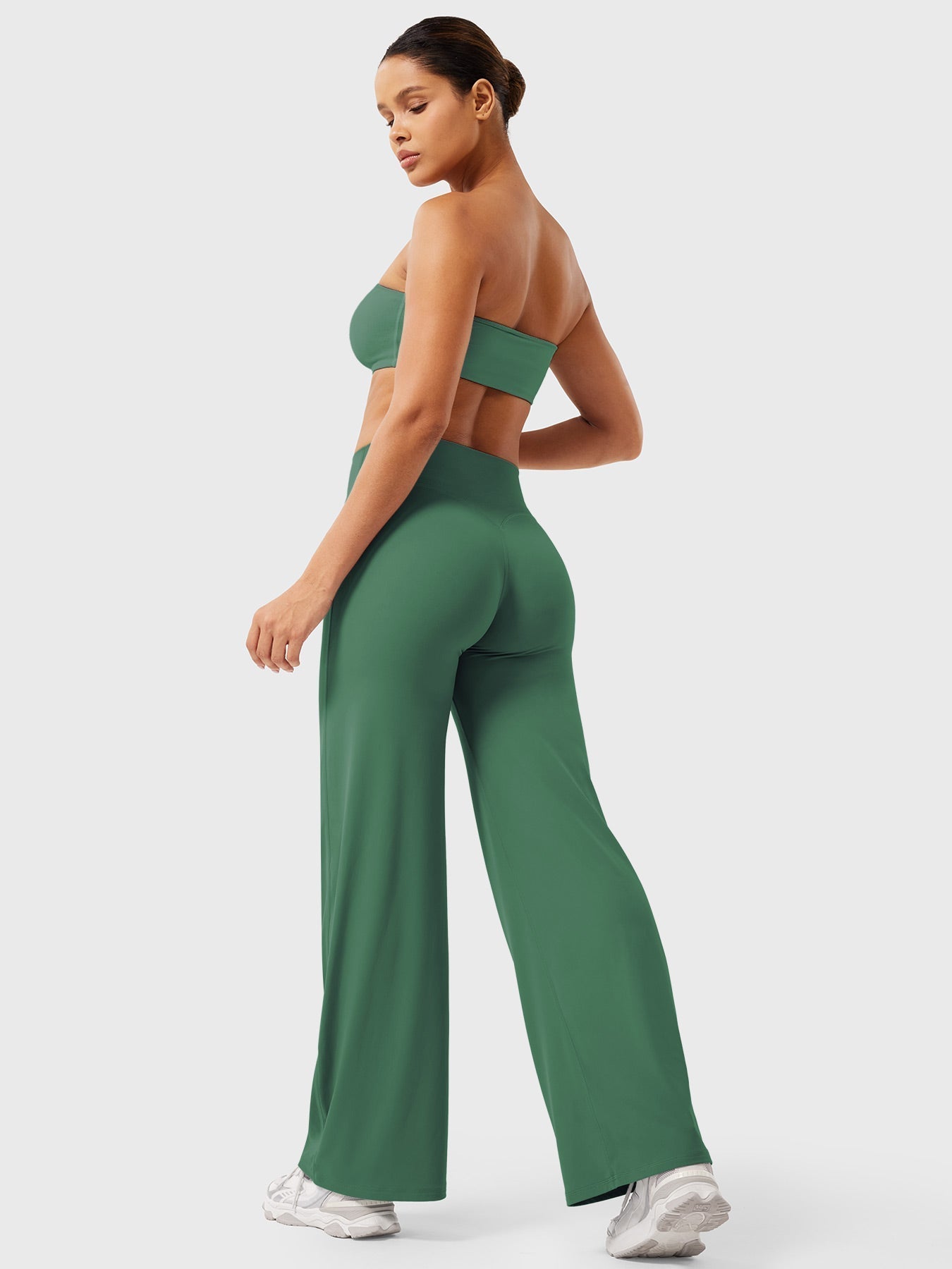 Dark green high waist flared pants for women by Jesie-London, styled as summer casual wear, shown on a model.