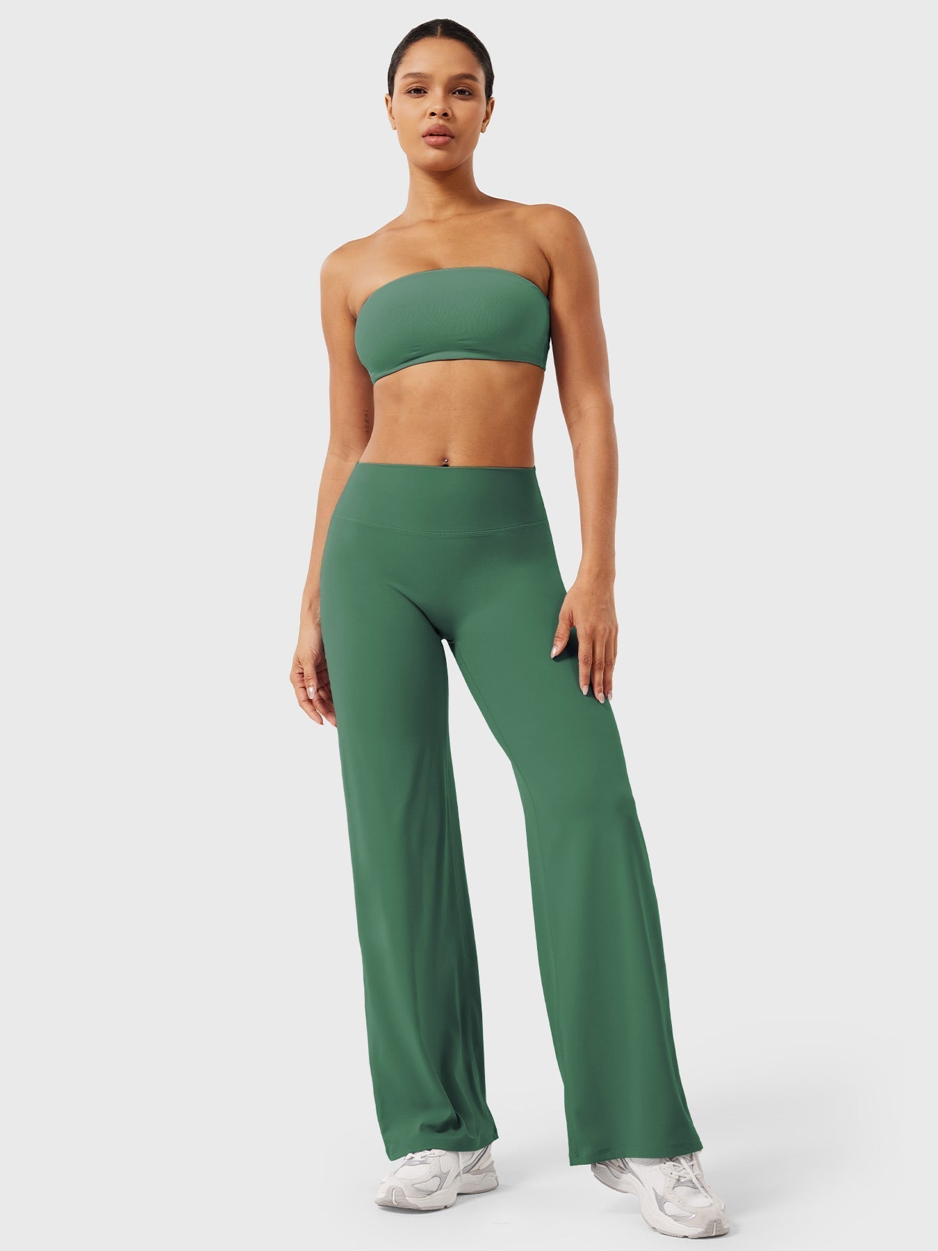 Dark green Millie women's summer high waist flared pants by Jesie-London, shown on a model, highlighting the flowy fit and high waist design.