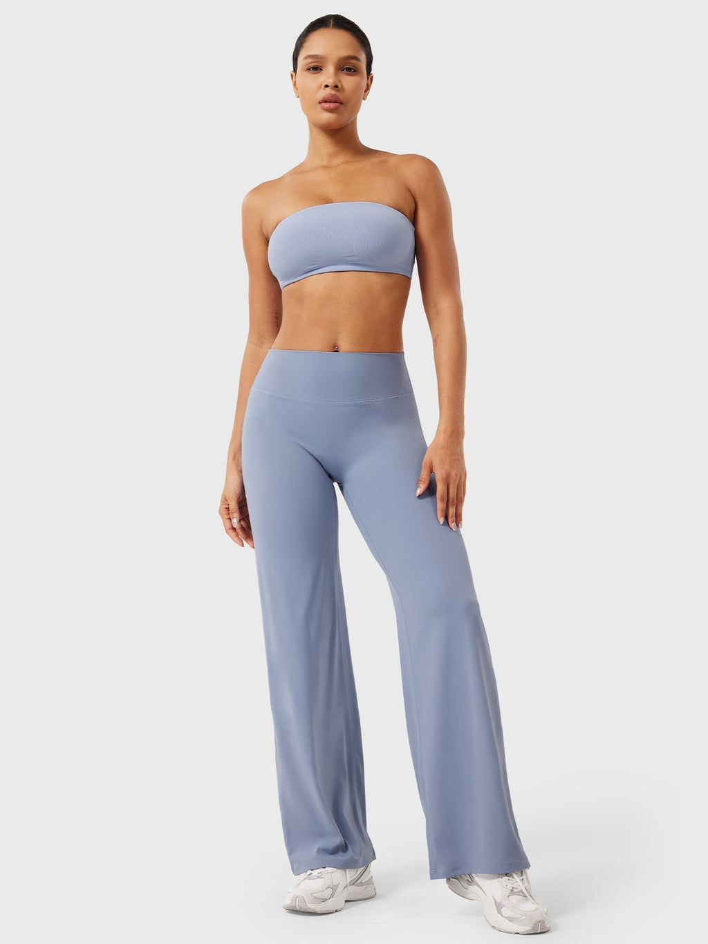 Millie women’s summer high waist flared pants in haze blue by Jesie-London, shown on a model with a relaxed fit and wide leg design.