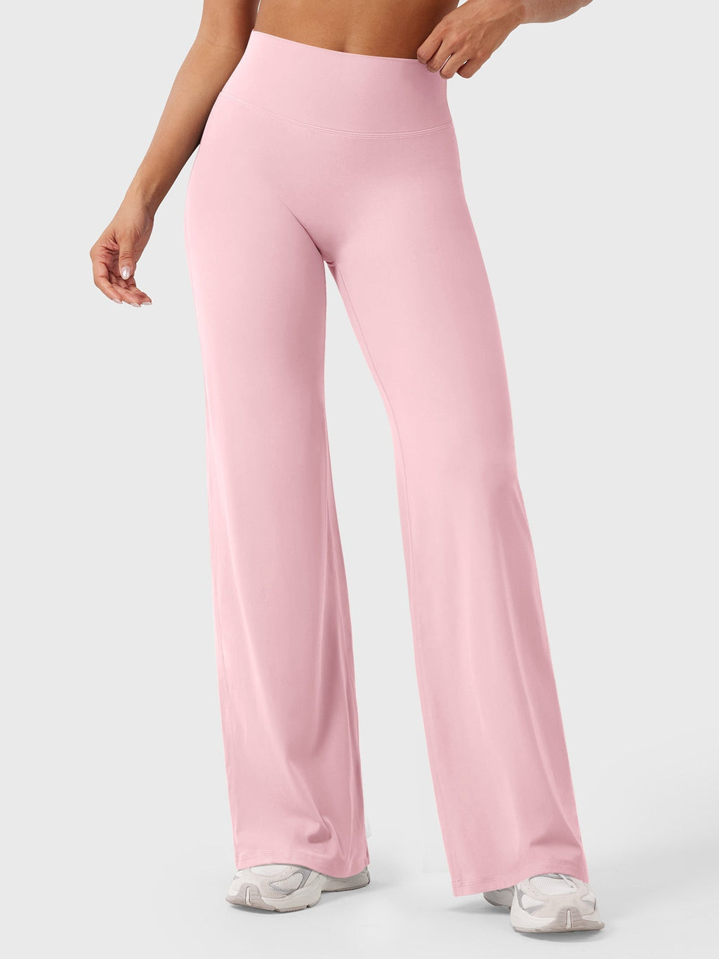 Light pink women's high waist flared pants from Jesie-London's Millie summer collection, shown on a model.