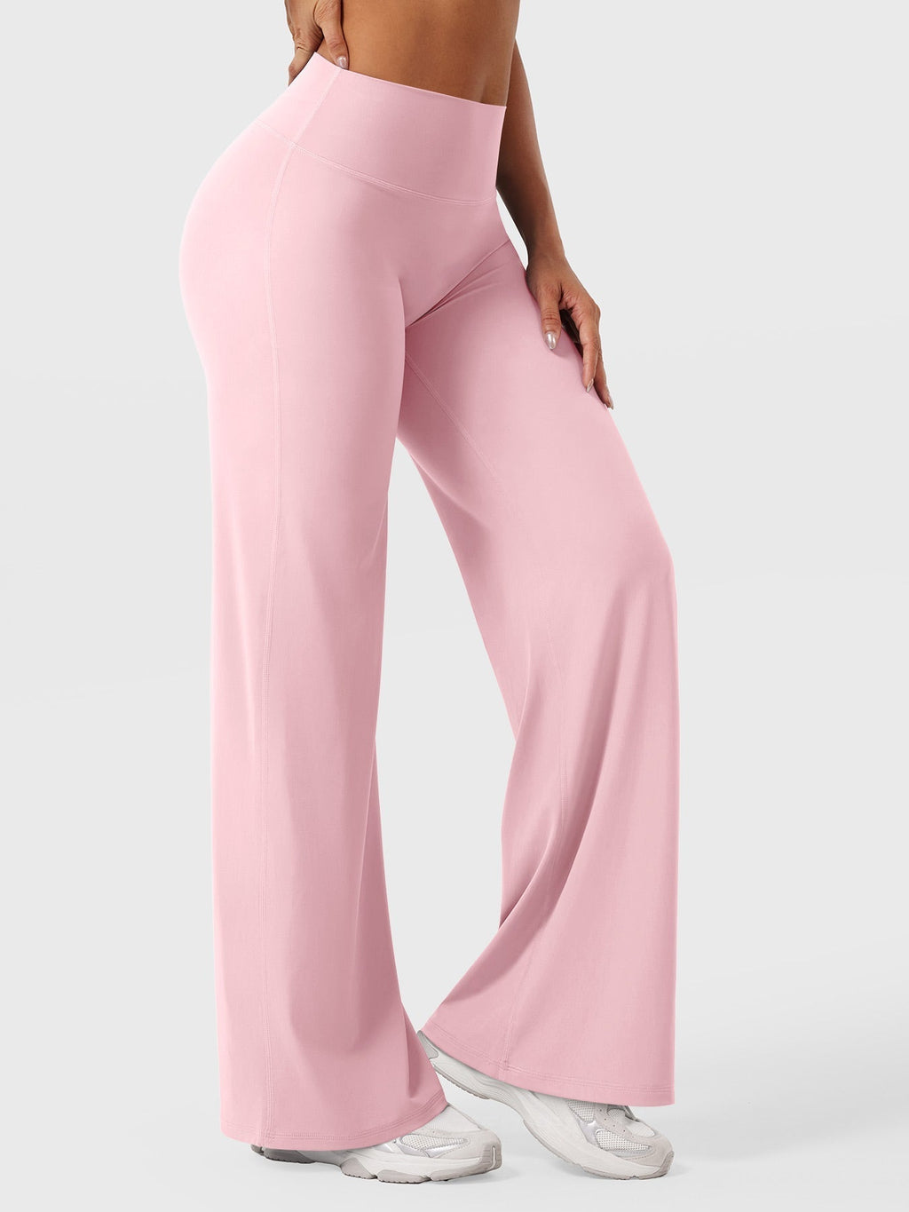 Light pink women's high waist flared pants from Jesie-London's Millie summer collection, shown on a model.