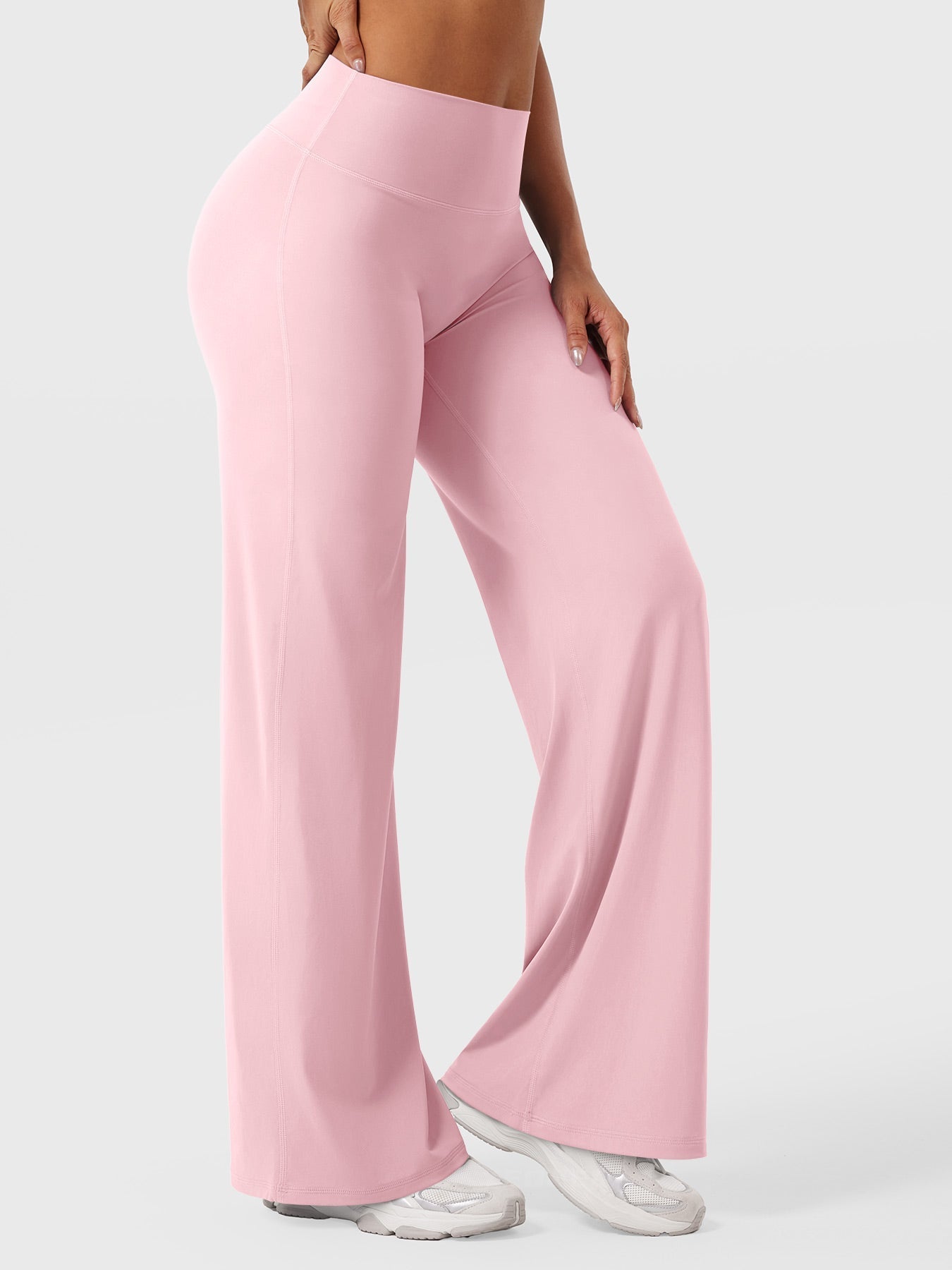 Light pink women's high waist flared pants from Jesie-London's Millie summer collection, shown on a model.