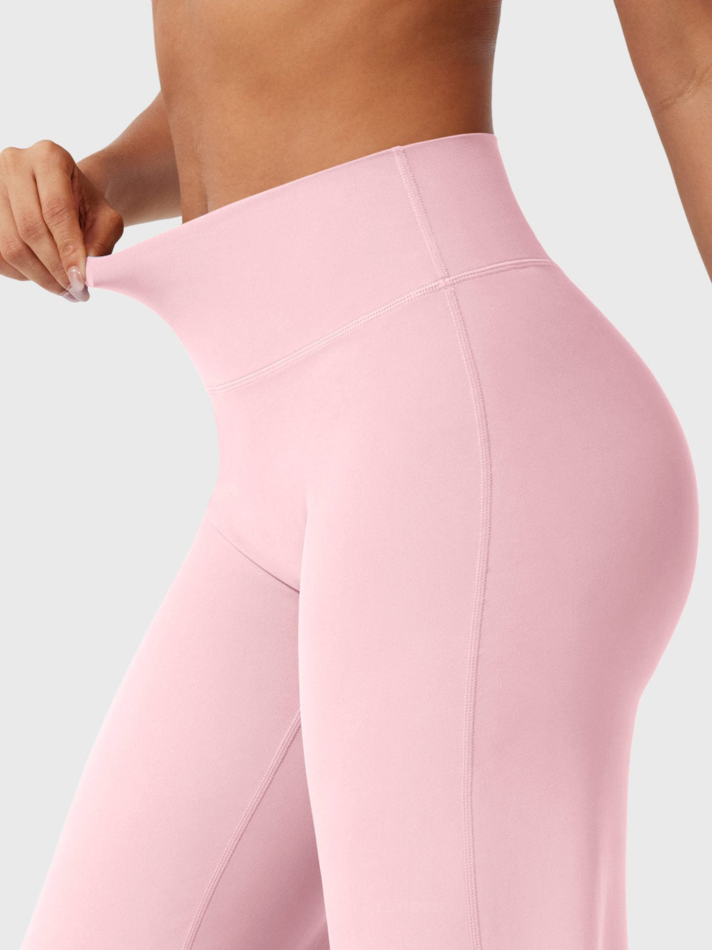 Light pink women's high waist flared pants from Jesie-London's Millie summer collection, styled with a relaxed fit and flowy fabric.