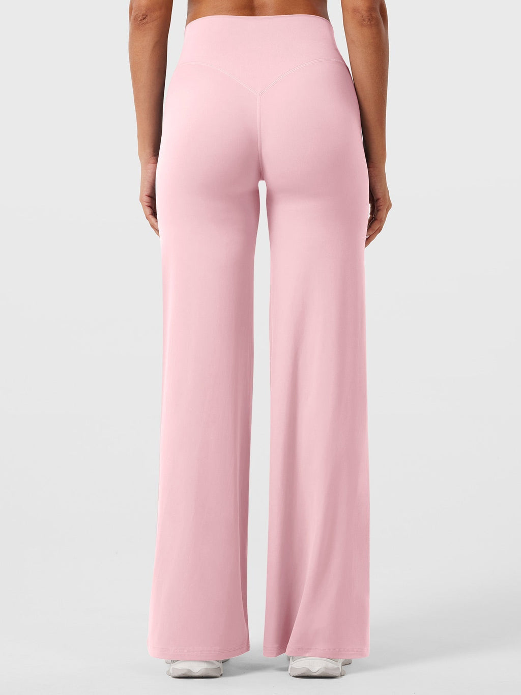 Light pink women's high waist flared pants from Jesie-London's Millie summer collection, styled with a relaxed fit and flowy design.