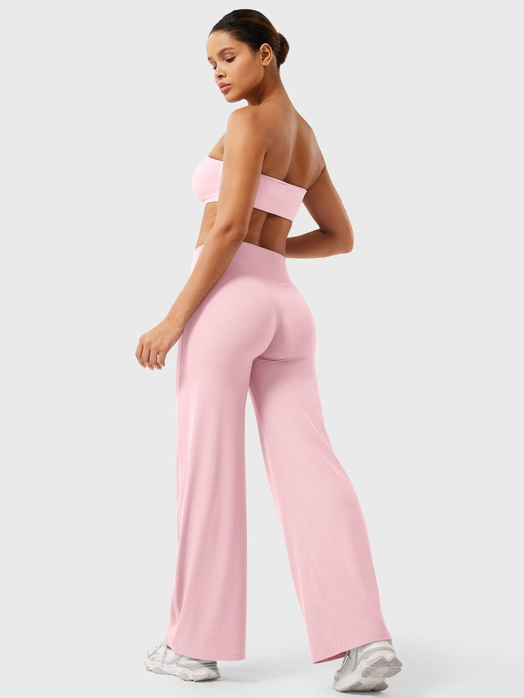 Light pink women's high waist flared summer pants from Jesie-London, featuring a stylish, flowy design and comfortable fit.