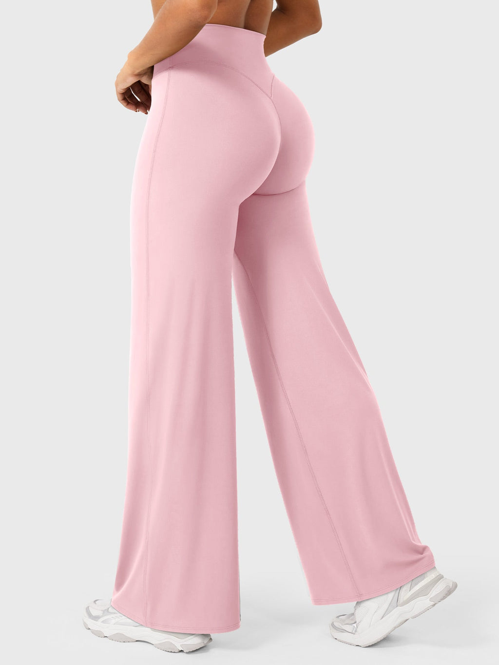 Light pink women's high waist flared pants from Jesie-London's Millie summer collection, styled as casual or chic wear.