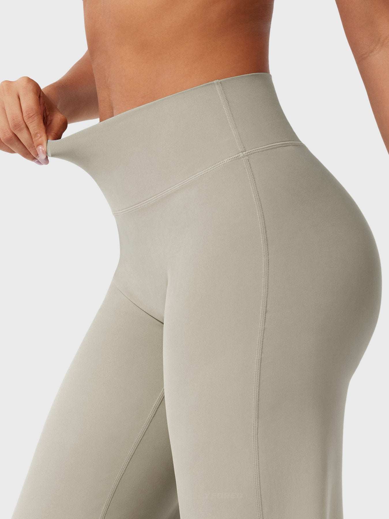 Light sand high waist flared pants for women by Jesie-London, featuring a summer-ready, stylish design and wide-leg silhouette.