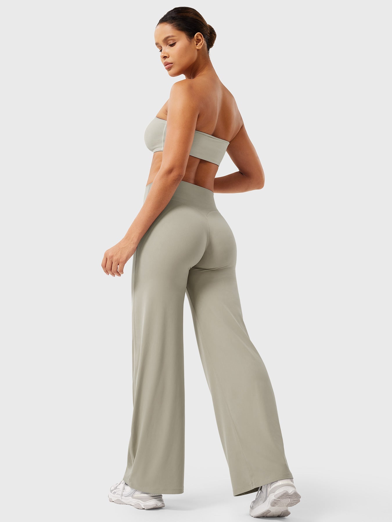 Light sand high waist flared pants for women by Jesie-London, featuring a summer-ready, wide-leg design and relaxed fit.