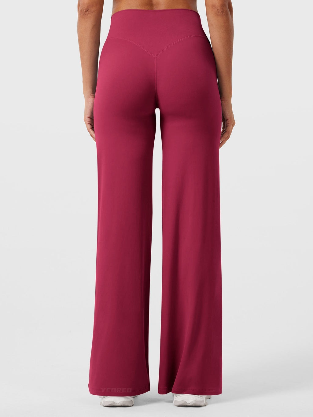 Women’s high waist flared summer pants in vibrant ruby red by Jesie-London, shown on a model.