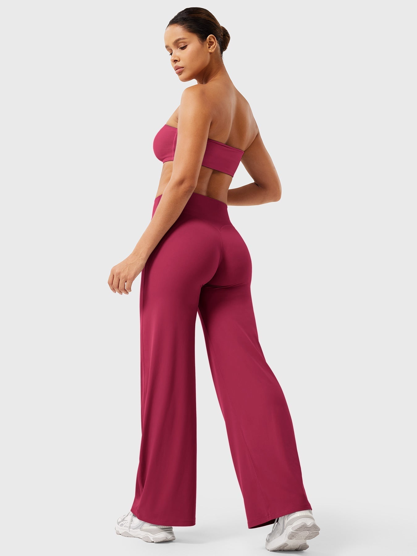 Women’s high waist flared pants in ruby red by Jesie-London, featuring a summer-ready, stylish silhouette and flowy fabric.