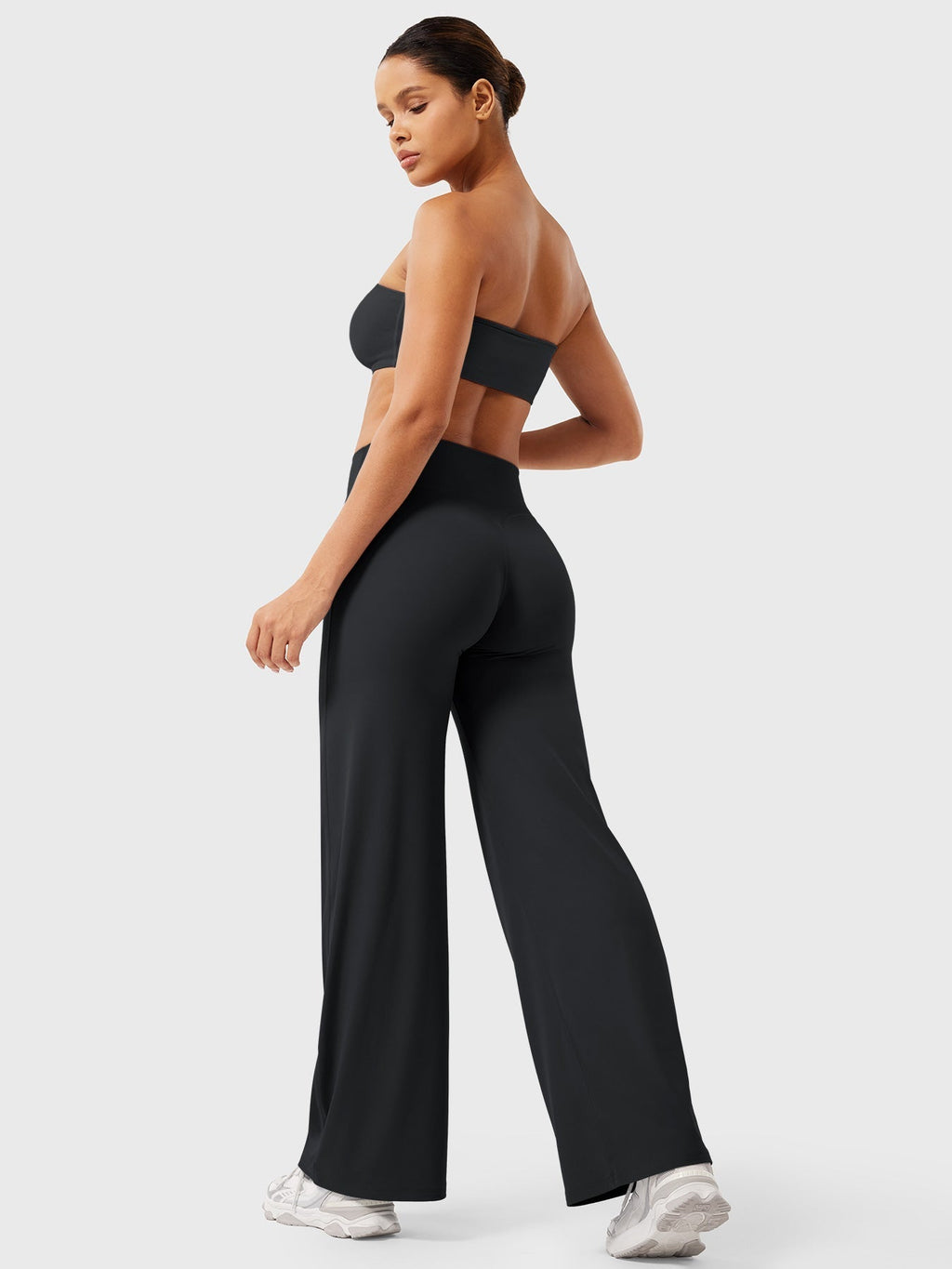 Black women's high waist flared pants from Jesie-London's Millie summer collection, showcasing a fitted waist and flared leg design.