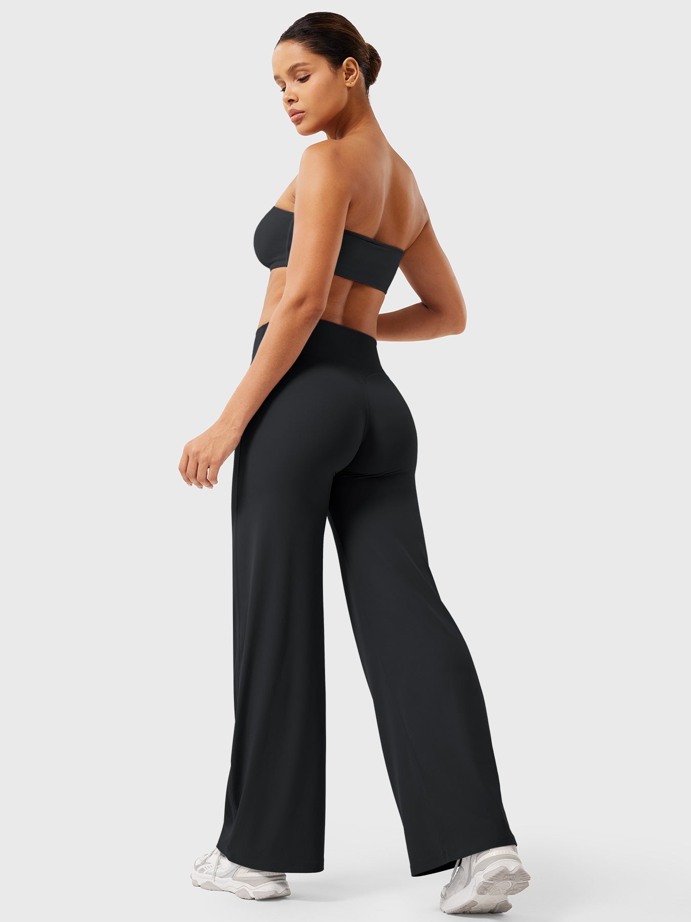 Black women's high waist flared pants from Jesie-London's Millie summer collection, showcasing a fitted waist and flared leg design.
